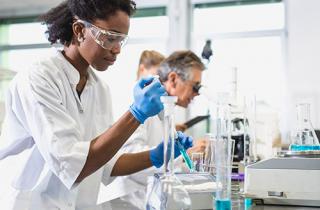 Biology student Using an Automatic Pipette