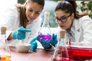 Two female students doing experiments in lab.