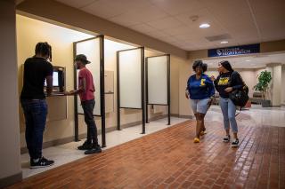 Students in the administration building hallway visiting offices