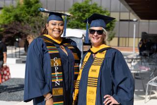 Two Coppin graduates smiling